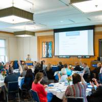 People sitting at tables at the event.